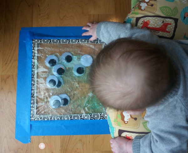 Tummy time sensory bag play! Such a fun baby play idea!