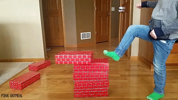 Balance activity that is so much fun! Use cardboard blocks to play these balance games that any kid or adult will love. This gross motor game can easily be adapted to increase or decrease the challenge! #balance #grossmotor 