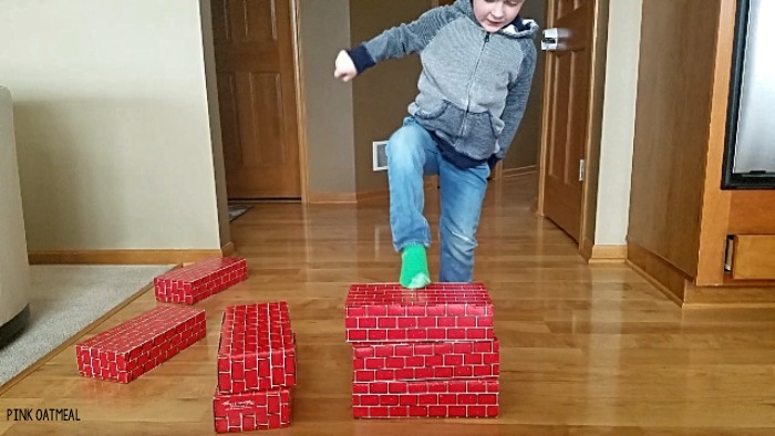 Balance activity that is so much fun! Use cardboard blocks to play these balance games that any kid or adult will love. This gross motor game can easily be adapted to increase or decrease the challenge! #balance #grossmotor 