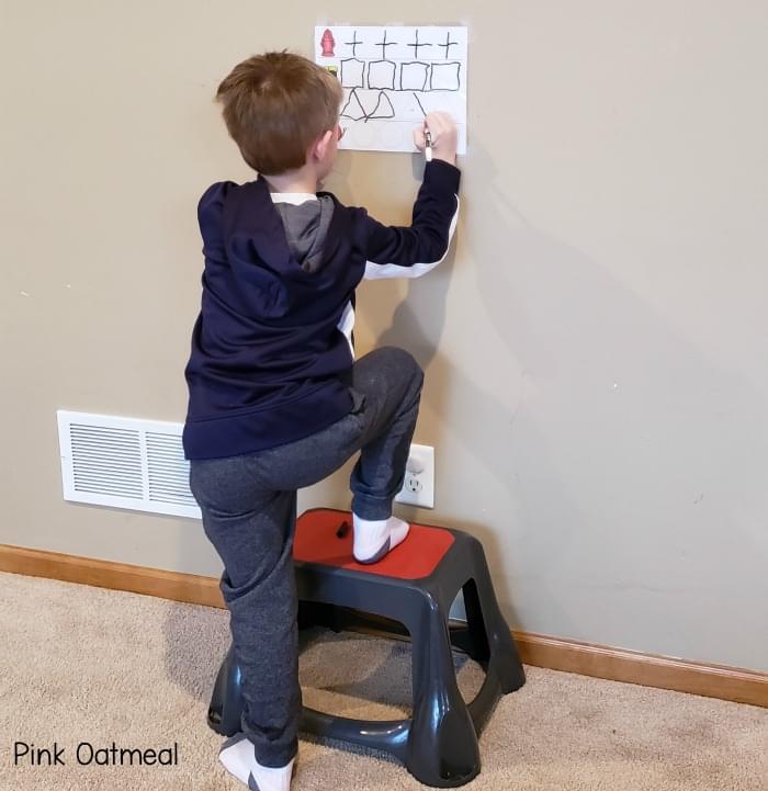 Balance exercises for kids - standing with one foot on the stool and one foot on the ground. 